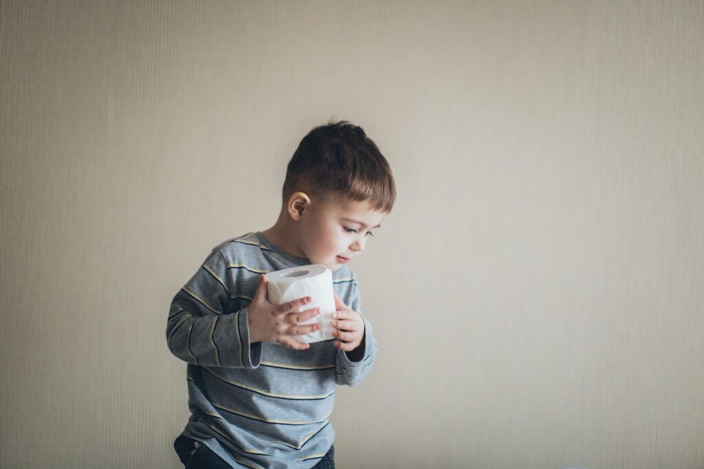Little boy holding toilet paper: Potty Training: Signs Your Child Is Ready